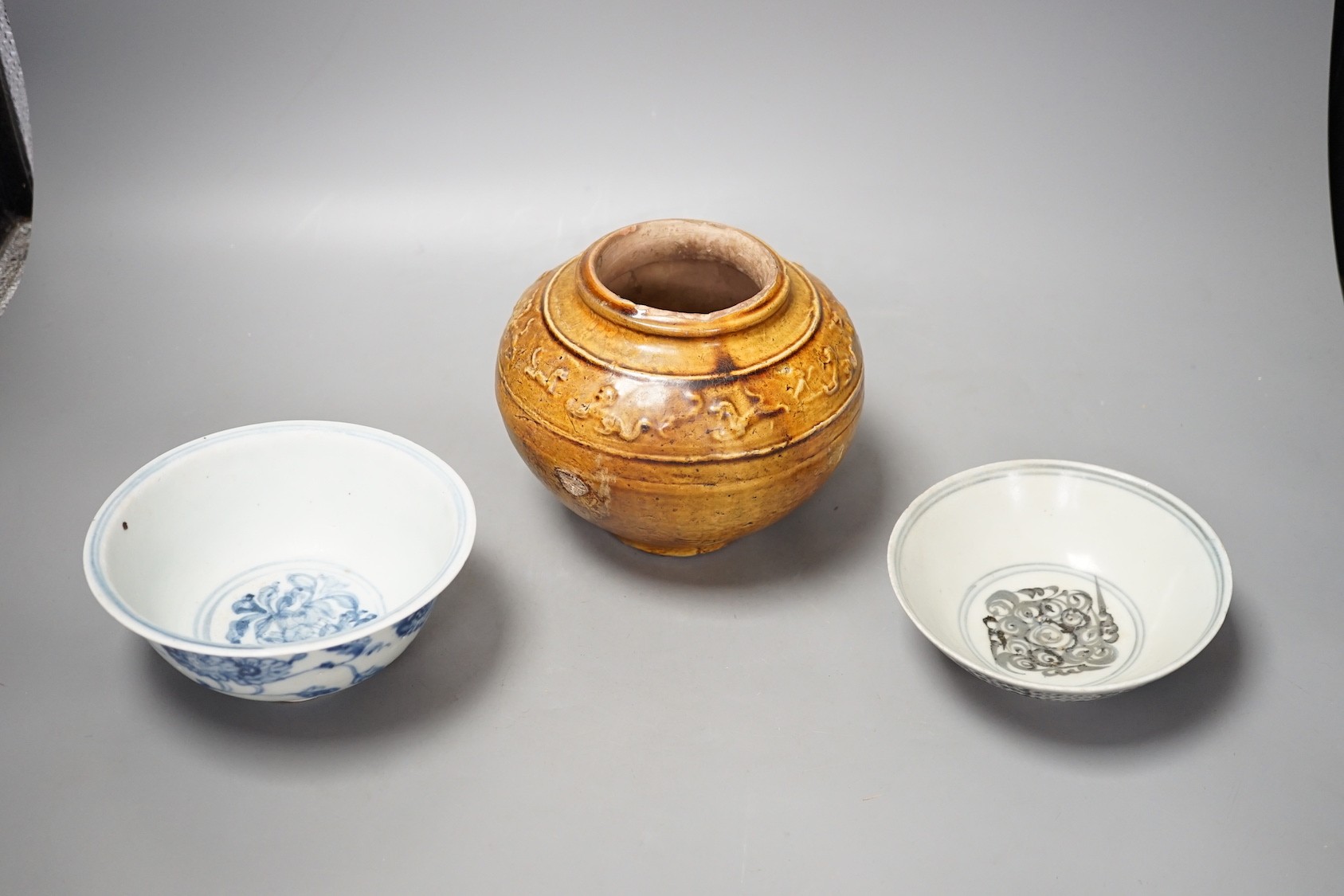 Two Chinese Ming blue and white bowls and a straw glazed jar of Martaban type - tallest 13cm